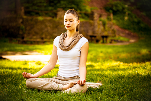 Person sitting with upright posture, feet flat and back straight